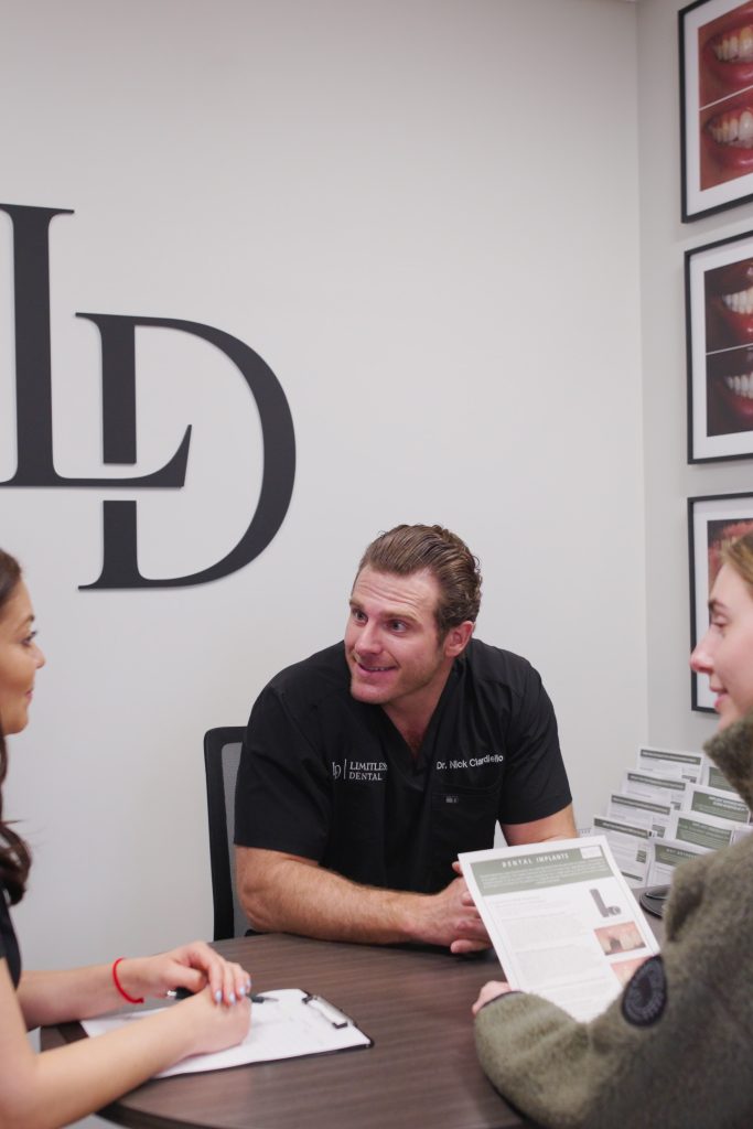 Dr. Nick Ciardiello of Limitless Dental in Jersey City consulting a patient about cosmetic dentistry options.