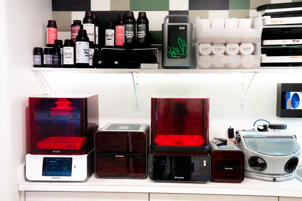 Lineup of three in-house 3D printers at Limitless Dental in Jersey City used to fabricate same-day veneers, crowns, and surgical guides for patient treatment.