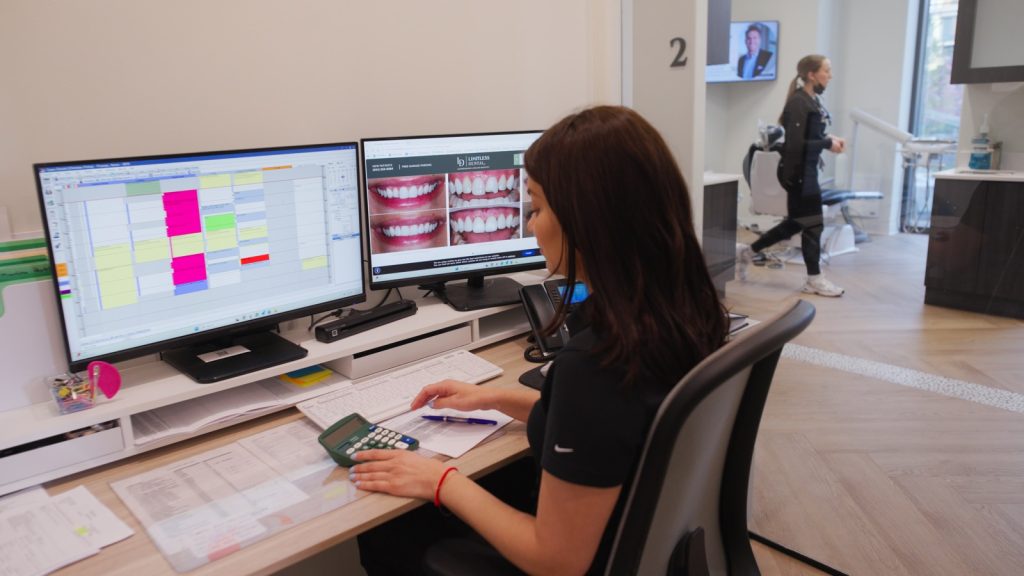 How much veneers cost in Jersey City. A Limitless Dental treatment coordinator reviewing porcelain veneer pricing and financing options with a patient.
