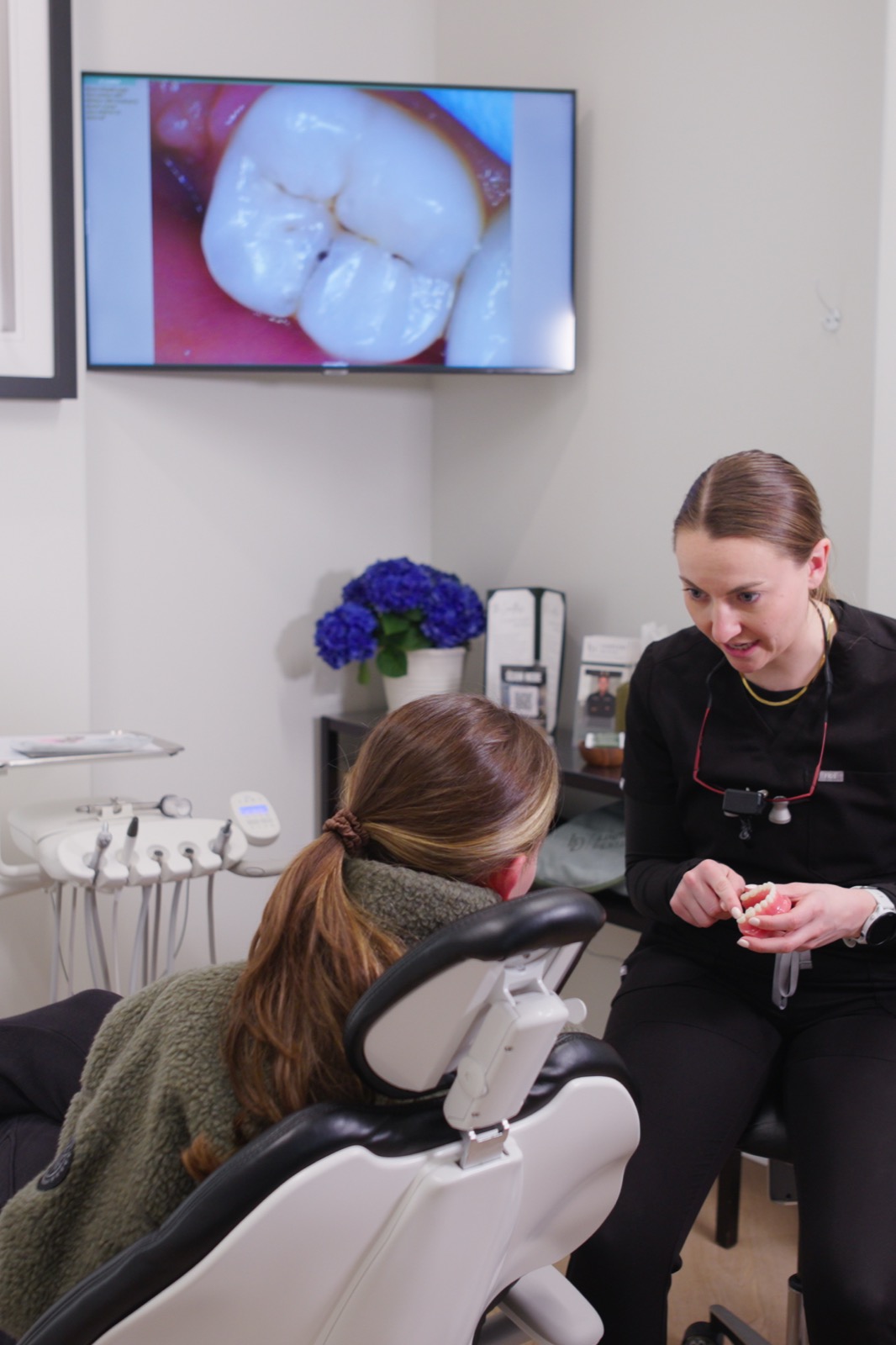Dr. Nick explaining a digital smile preview using a dental model at Limitless Dental® in Jersey City.