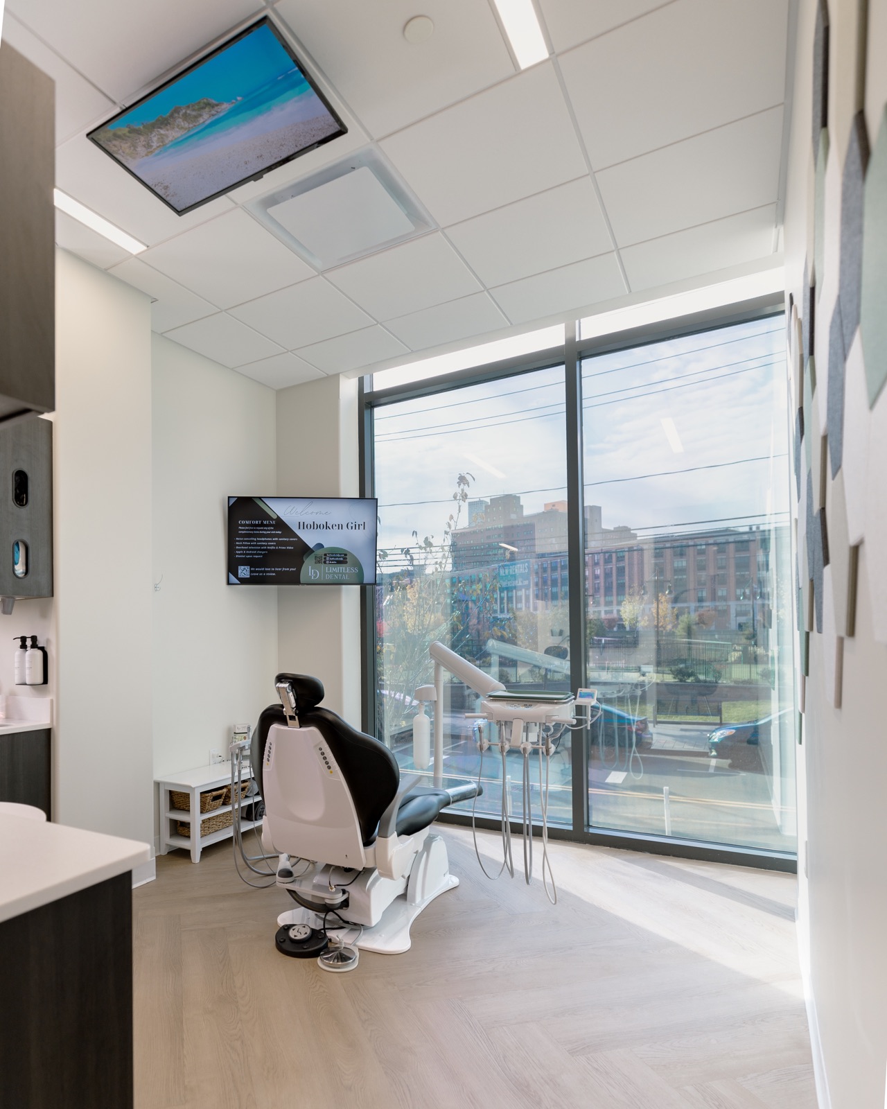 Treatment room at Limitless Dental in Jersey City with a ceiling-mounted television and the comfort menu on screen