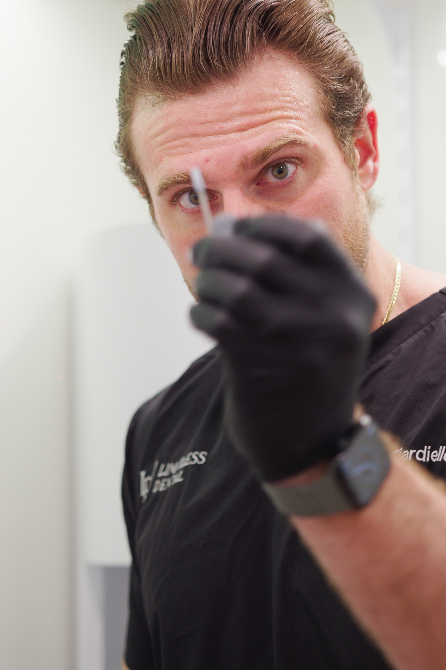 Dr. Nick Ciardiello at Limitless Dental in Jersey City demonstrating dental needle for numbing during an emergency dental procedure