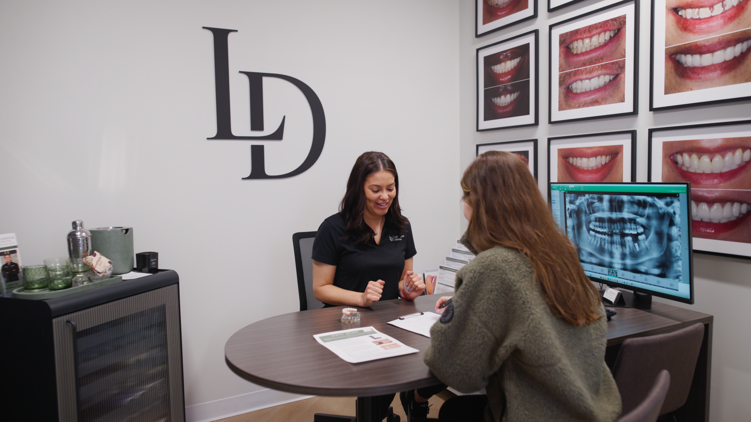 Dr. Nick Ciardiello explaining a wisdom teeth X-ray to a patient at Limitless Dental in Jersey City.